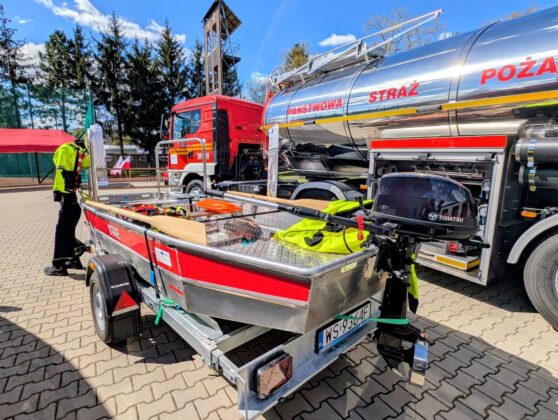 Ł&oacute;dź i w&oacute;z strażacki stoją obok siebie